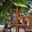 Děti si hrají na Triangle Modern Nature wooden playhouse with slide.