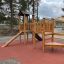 Triangle Modern Nature wooden playhouse with slide na hřišti.