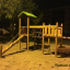 Triangle Modern Nature wooden playhouse with slide v noci