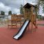 Triangle Modern Nature wooden playhouse with slide na hřišti