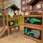 Jungle House playhouse with slide na hřišti.
