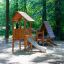 Galapagos wooden playhouse with slide v prostředí lesního hřiště