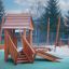 Tambora wooden playhouse with slide na venkovním hřišti