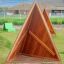 Herní zařízení Tipi Nature wooden house z přírodního dřeva na zelené trávě