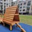 Kanha wooden playhouse with slide na moderním dvoře bytového domu