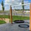 Dřevěná Double Swing Robinia (BNS 90) na hřišti s pneumatikovým sedátkem.