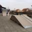 Vysoká skate rampa Quarter-Pipe s hrajícími si dětmi