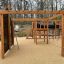 Motor Function Center Nature, wooden playhouse s lezeckou stěnou, opičími hrazdami a skluzavkou.