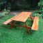 Venkovní Larchwood Table & Bench na zelené trávě.
