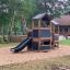 Knight's Castle Nature playhouse with slide v lesním hřišti