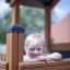 Dítě si hraje v Tower Nature wooden playhouse with slide.