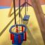 Swing Frame (double swing) na hřišti s modrým sedátkem a bezpečnostní dětskou židličkou.