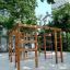 Chimpanzee wooden playhouse na hřišti obklopeném stromy.