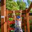 Dítě si hraje na Activity Center wooden playhouse