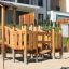 Rubik Modern Nature wooden playhouse with slide na dětském hřišti.